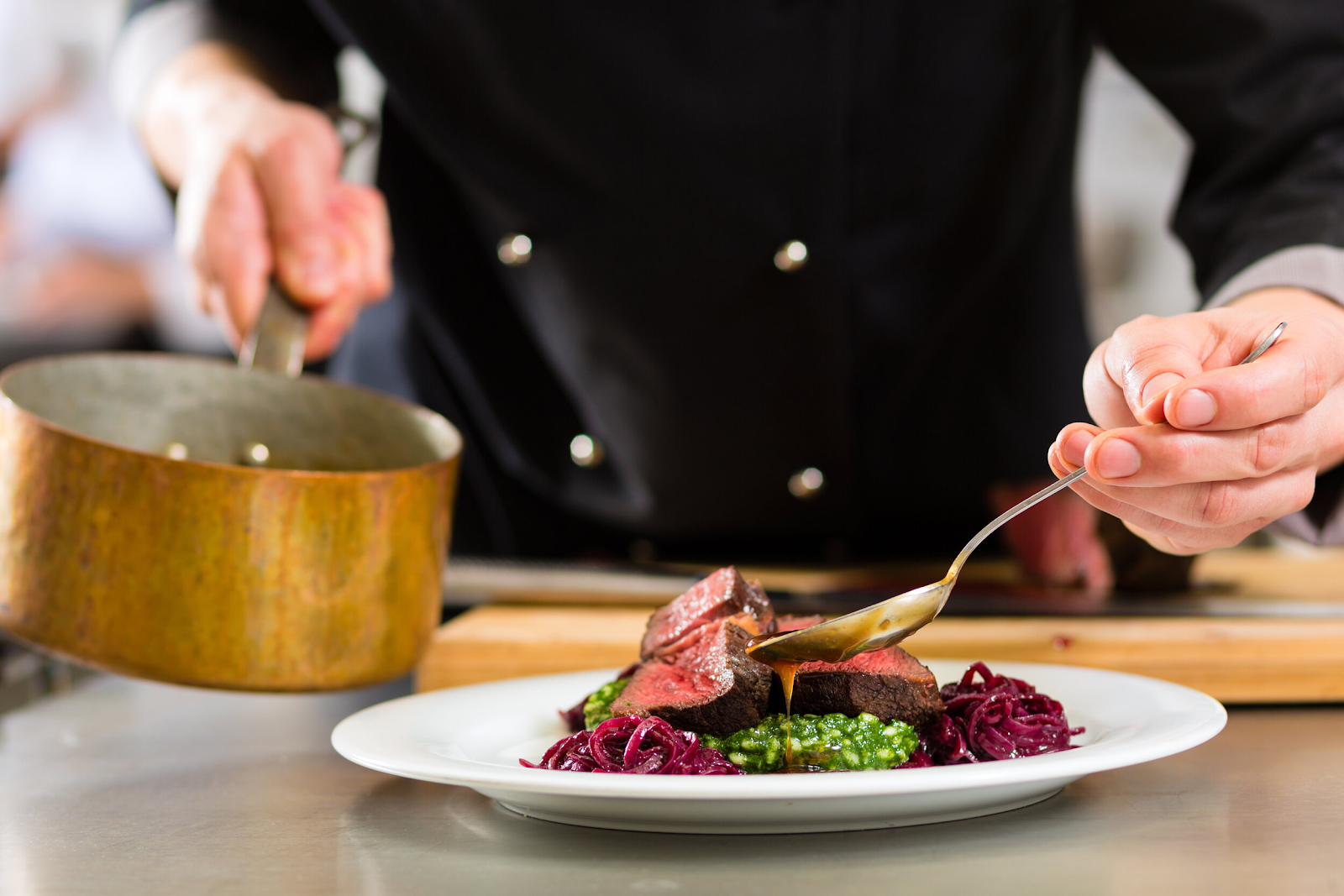 a chef basting a steak